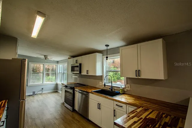 a kitchen with a stove a sink and a refrigerator