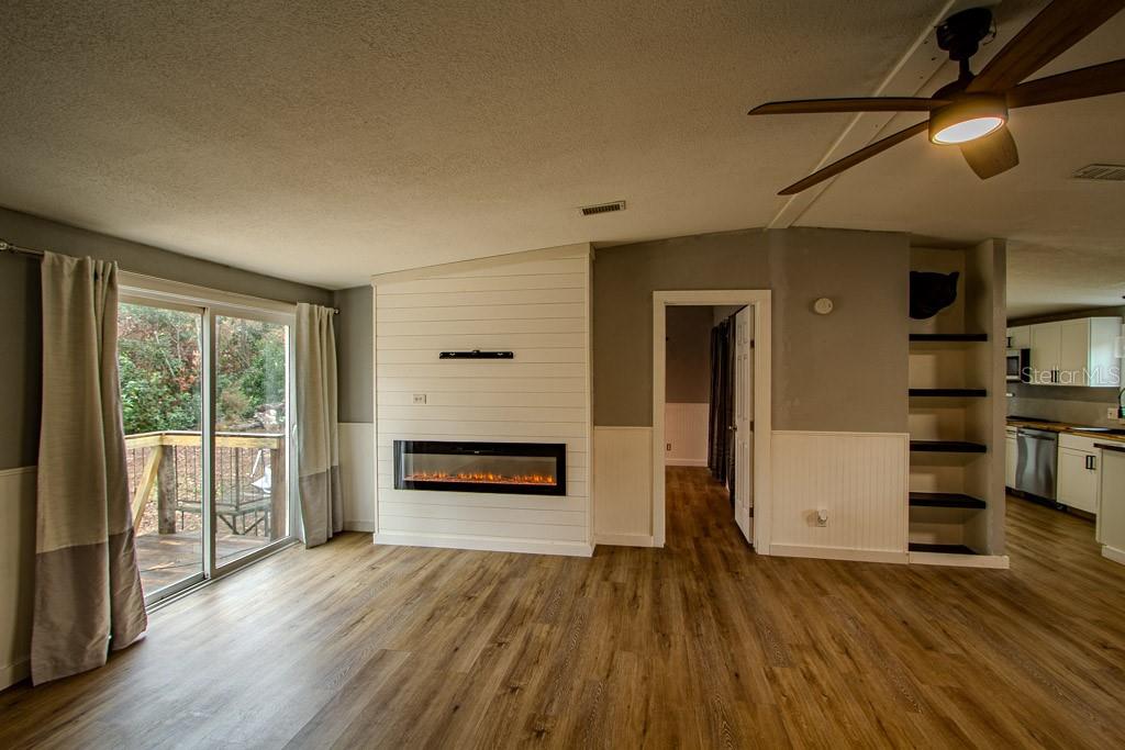 448 Southwest Central Terrace Fort White, FL 32038 - Photo 10 of 19 wooden floor in an empty room with a fireplace