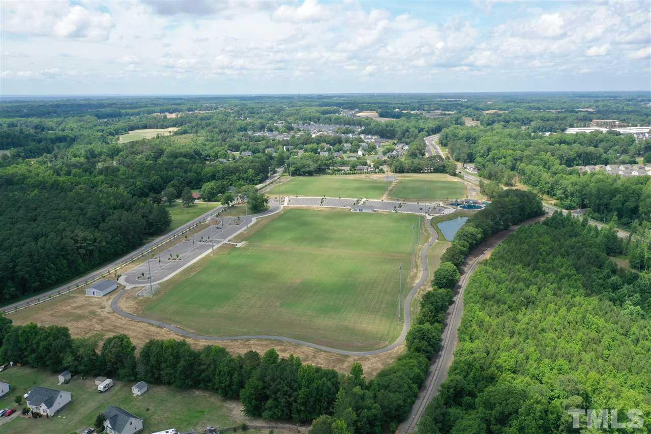 0 Fleming Loop Road Fuquay-Varina, NC 27526 - Photo 4 of 7 an aerial view of residential houses with outdoor space and trees