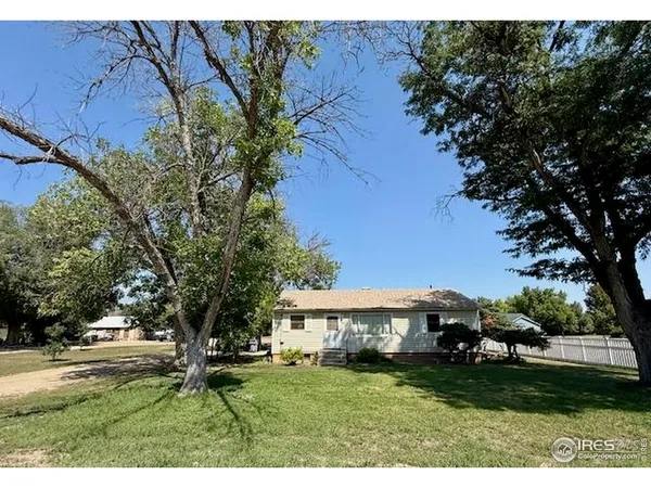 a view of a yard with a house in the background