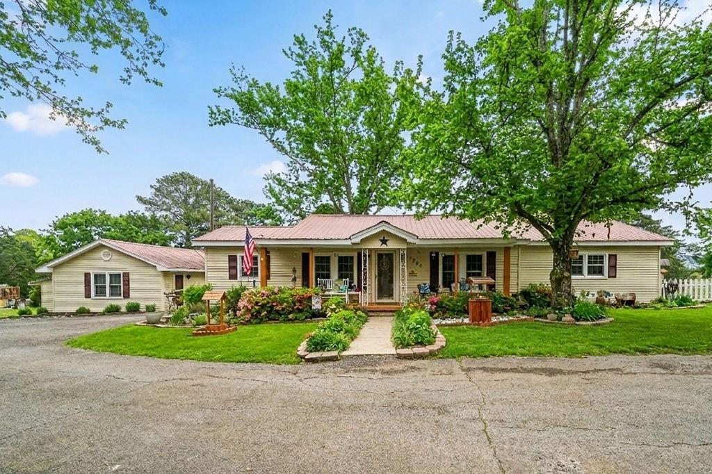 a front view of a house with a garden