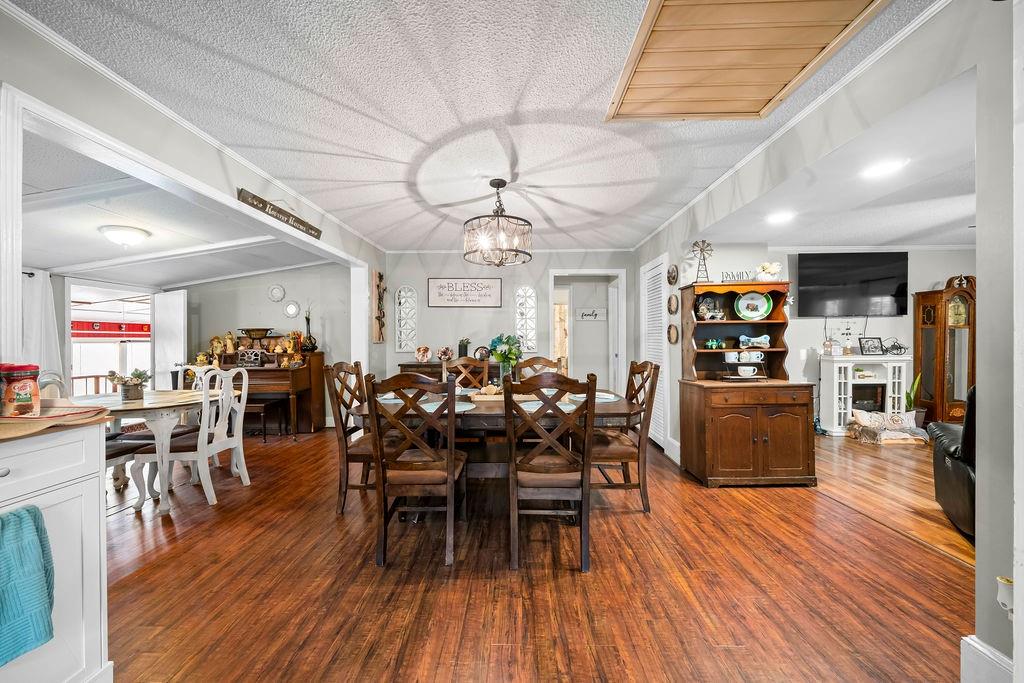 1763 Burnett Ferry Road Southwest Rome, GA 30165 - Photo 11 of 31 a view of a dining room with furniture and wooden floor