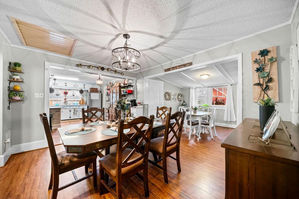 1763 Burnett Ferry Road Southwest Rome, GA 30165 - Photo 12 of 31 a view of a dining room with furniture wooden floor and chandelier
