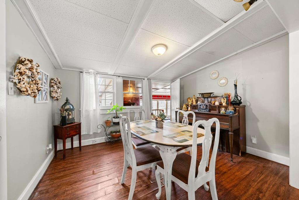 1763 Burnett Ferry Road Southwest Rome, GA 30165 - Photo 13 of 31 a view of a dining room with furniture and wooden floor