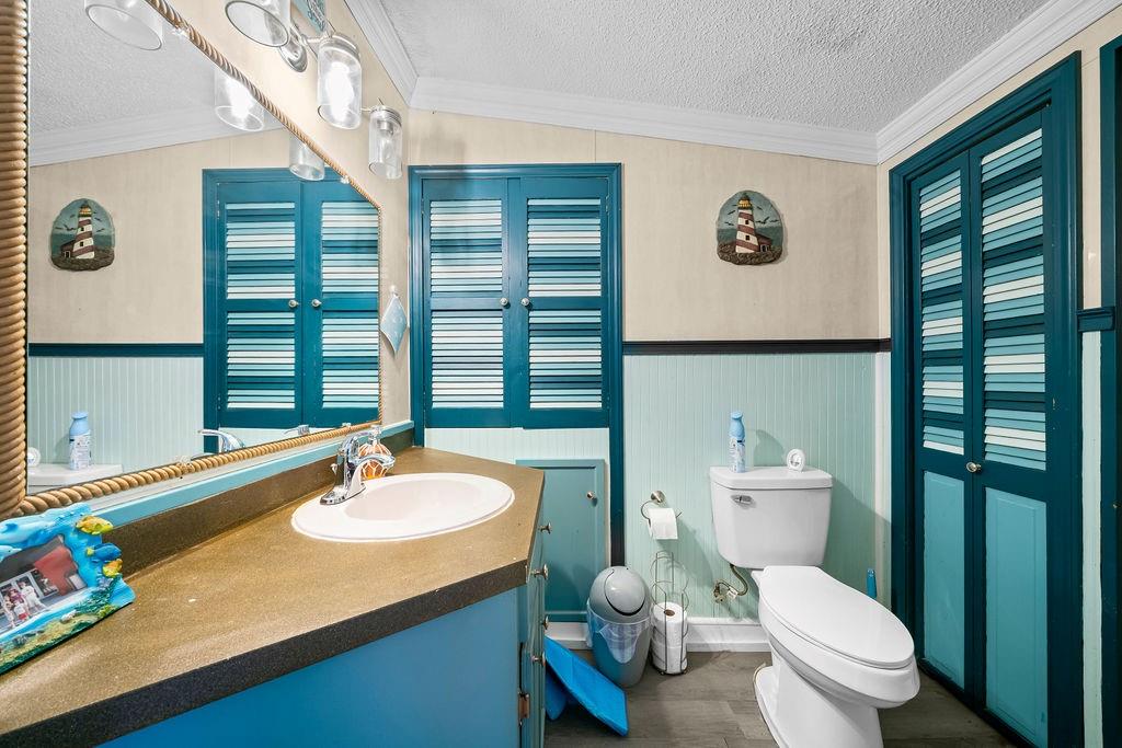 1763 Burnett Ferry Road Southwest Rome, GA 30165 - Photo 14 of 31 a bathroom with a sink a toilet and a large mirror