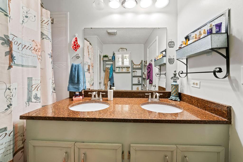 1763 Burnett Ferry Road Southwest Rome, GA 30165 - Photo 18 of 31 a bathroom with a granite countertop sink and a mirror