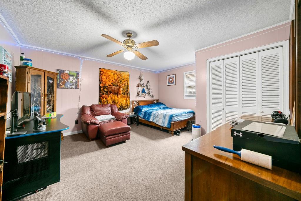 1763 Burnett Ferry Road Southwest Rome, GA 30165 - Photo 19 of 31 a living room with furniture flat screen tv and window