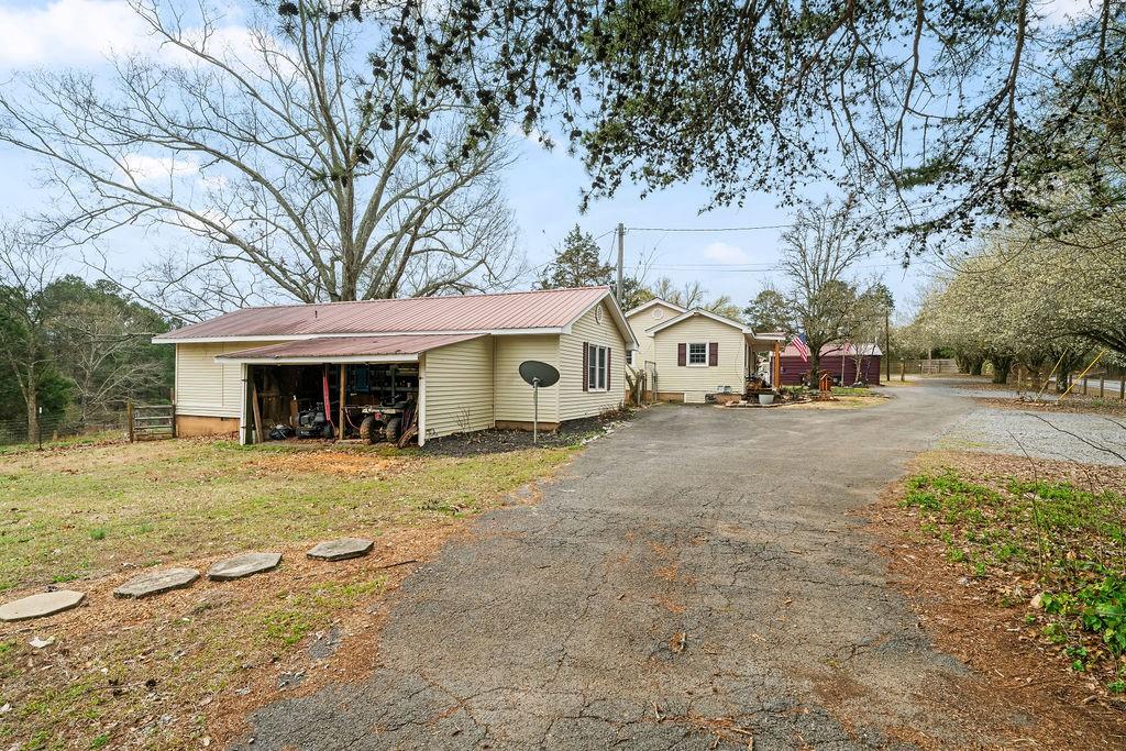 1763 Burnett Ferry Road Southwest Rome, GA 30165 - Photo 25 of 31 a front view of a house with garden