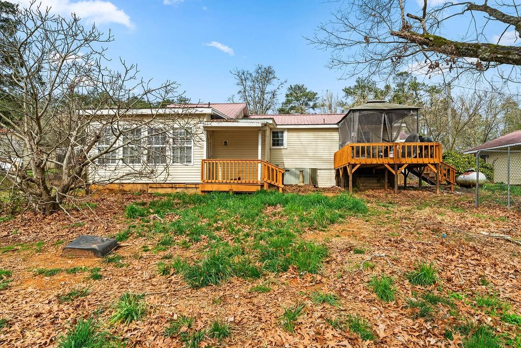 1763 Burnett Ferry Road Southwest Rome, GA 30165 - Photo 26 of 31 a view of a house with a big yard and large trees