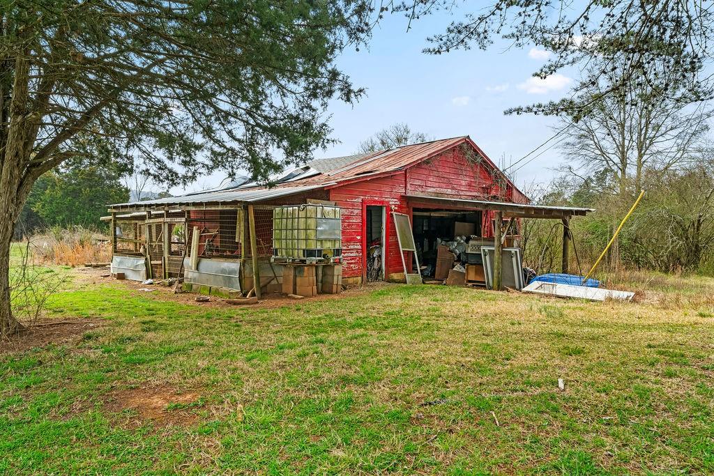 1763 Burnett Ferry Road Southwest Rome, GA 30165 - Photo 28 of 31 a view of a house with a yard and sitting area