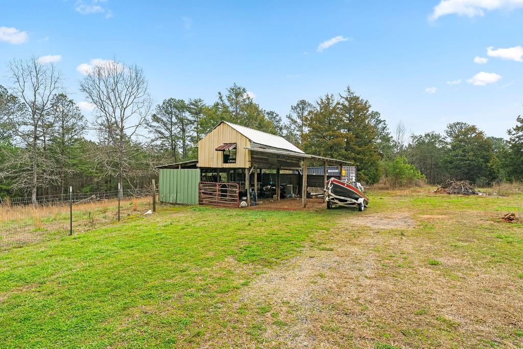 1763 Burnett Ferry Road Southwest Rome, GA 30165 - Photo 30 of 31 a view of a house with backyard and a tree