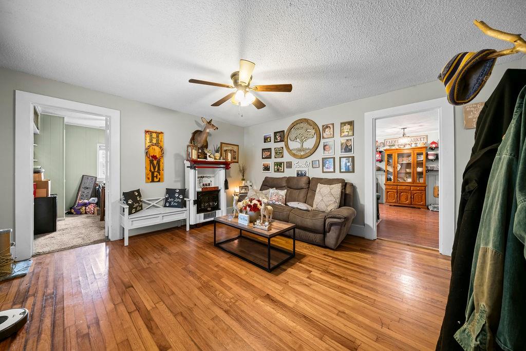 1763 Burnett Ferry Road Southwest Rome, GA 30165 - Photo 5 of 31 a living room with fireplace furniture and a wooden floor