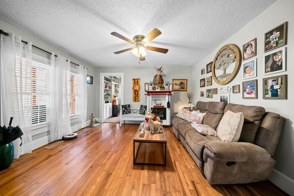 1763 Burnett Ferry Road Southwest Rome, GA 30165 - Photo 6 of 31 a living room with furniture a fireplace and window