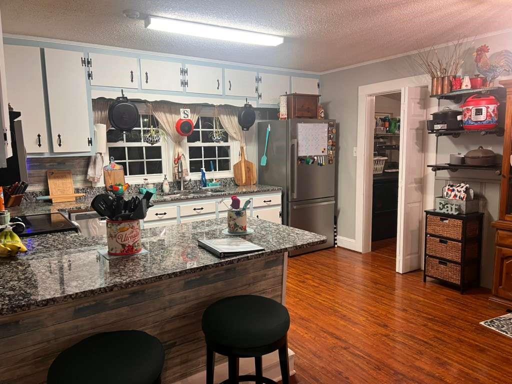 1763 Burnett Ferry Road Southwest Rome, GA 30165 - Photo 8 of 31 a kitchen with stainless steel appliances granite countertop a sink refrigerator and cabinets