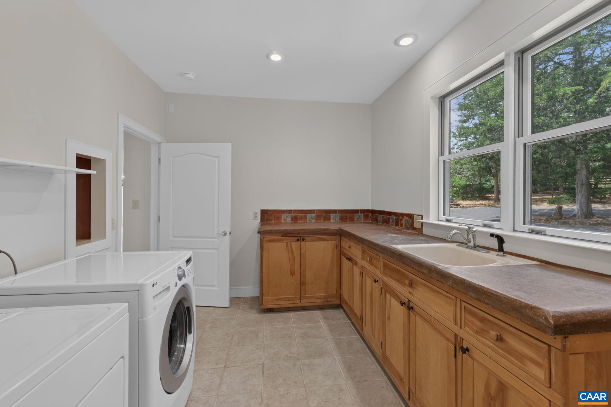 6285 Jarmans Gap Road Crozet, VA 22932 - Photo 28 of 65 a utility room with cabinets washer and dryer