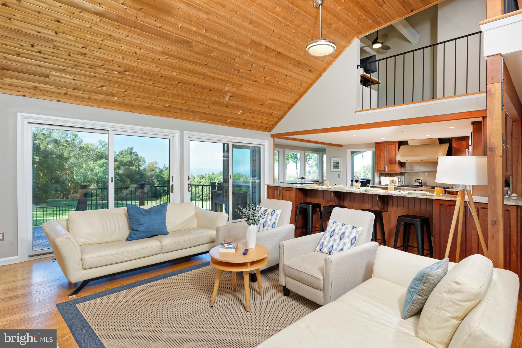 20615 Blue Ridge Mountain Road Paris, VA 20130 - Photo 15 of 80 a living room with furniture a fireplace and a large window