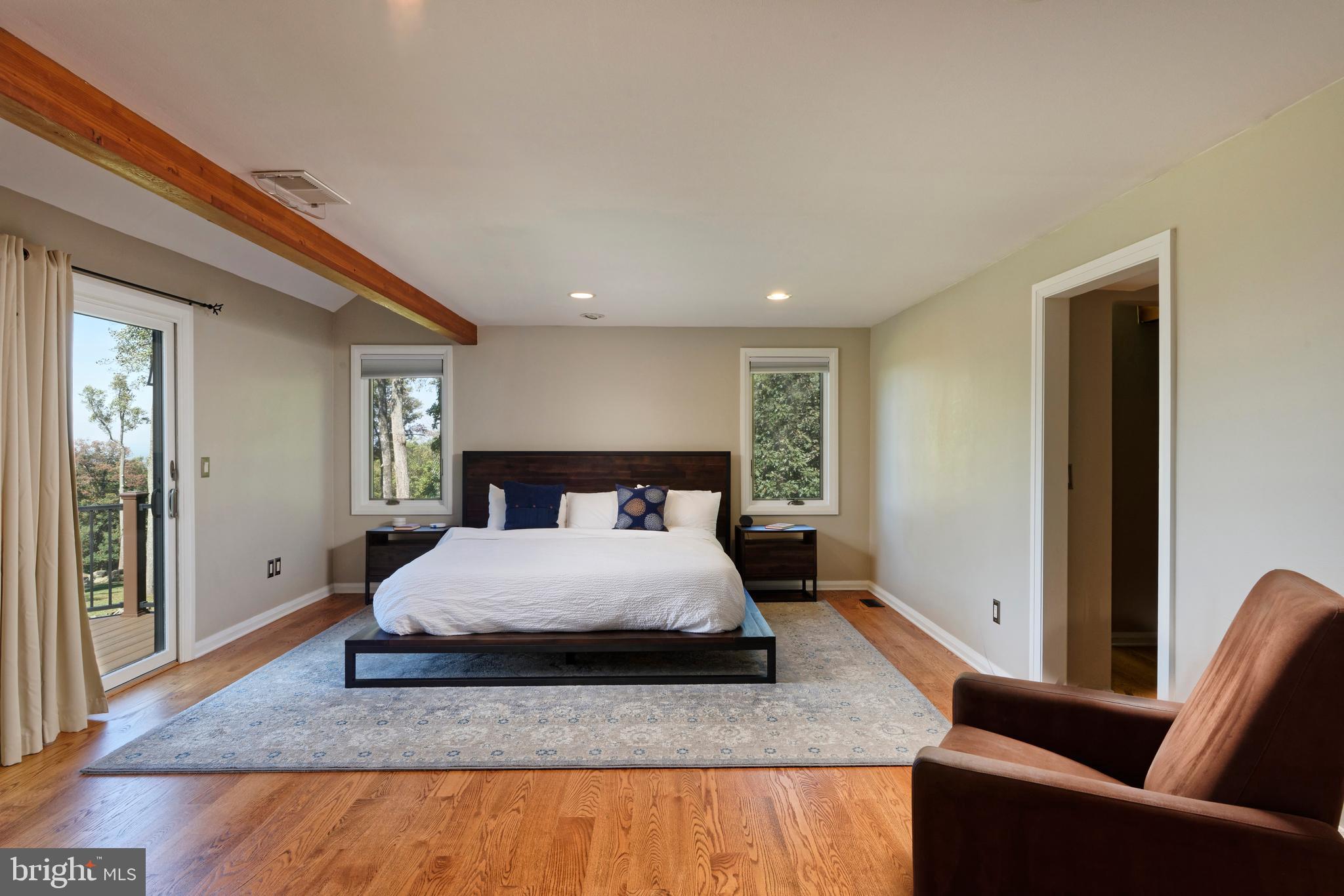 20615 Blue Ridge Mountain Road Paris, VA 20130 - Photo 18 of 80 a spacious bedroom with a bed and wooden floor