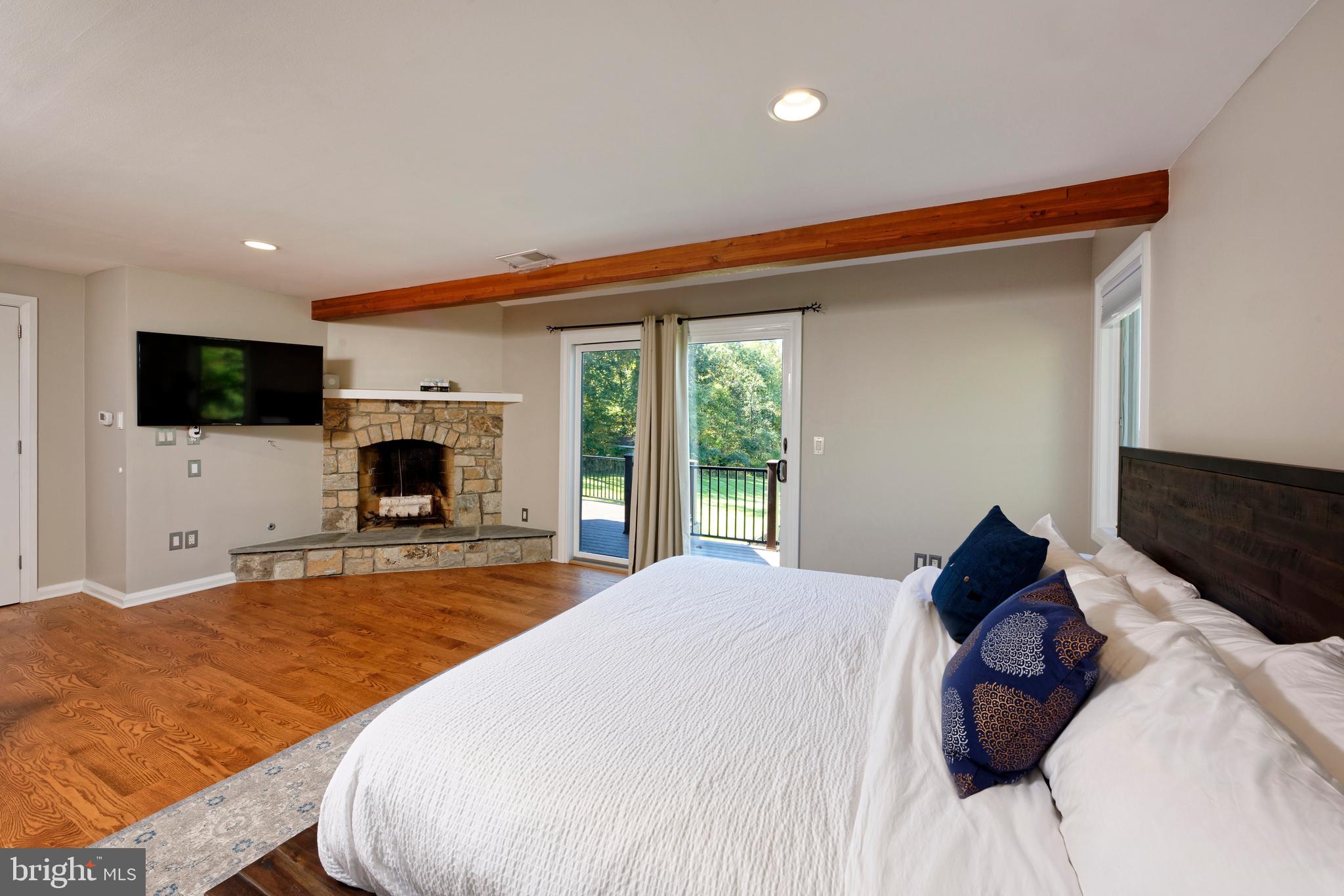 20615 Blue Ridge Mountain Road Paris, VA 20130 - Photo 19 of 80 a bedroom with a bed and a flat screen tv