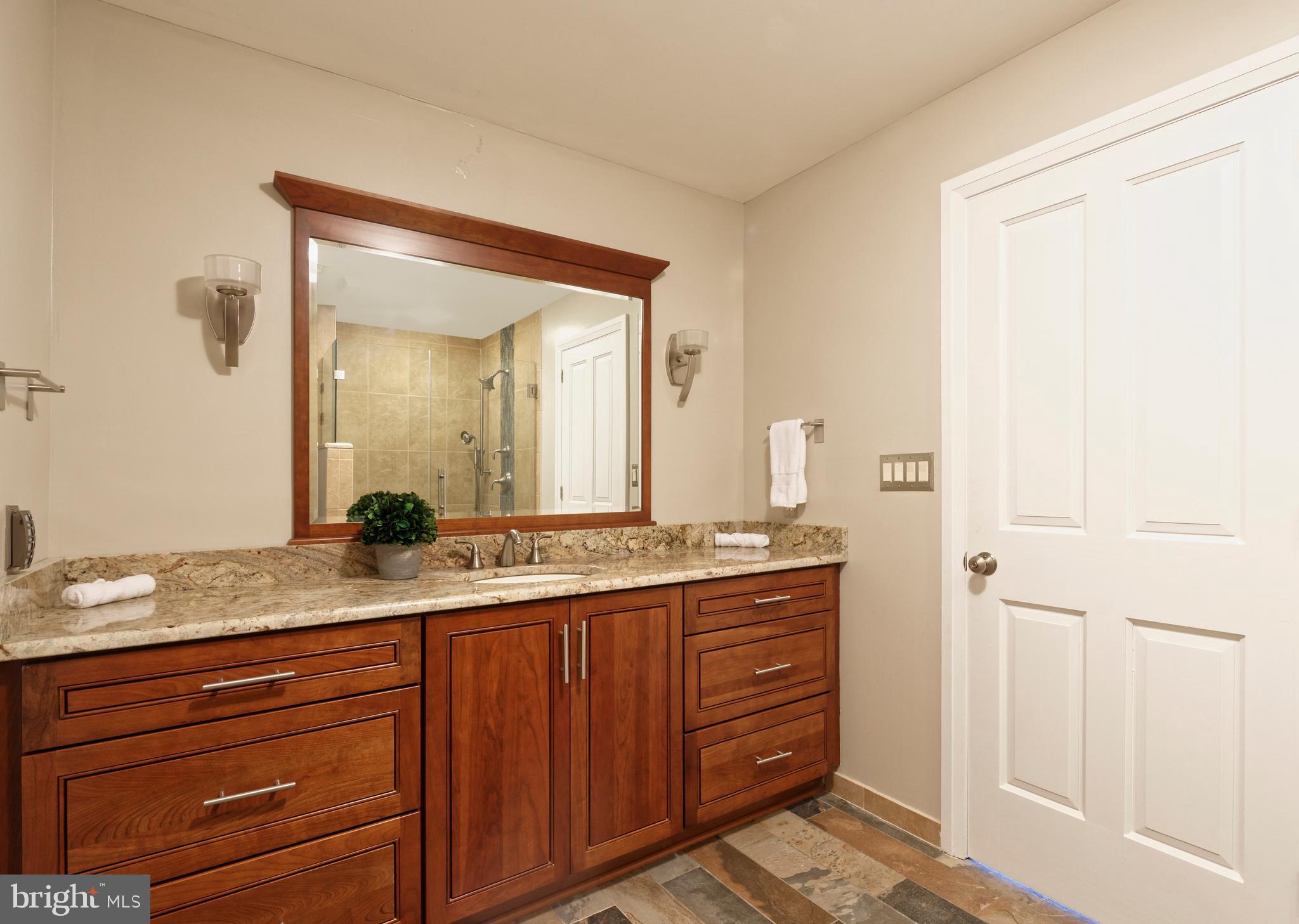 20615 Blue Ridge Mountain Road Paris, VA 20130 - Photo 37 of 80 a bathroom with a granite countertop sink and a mirror