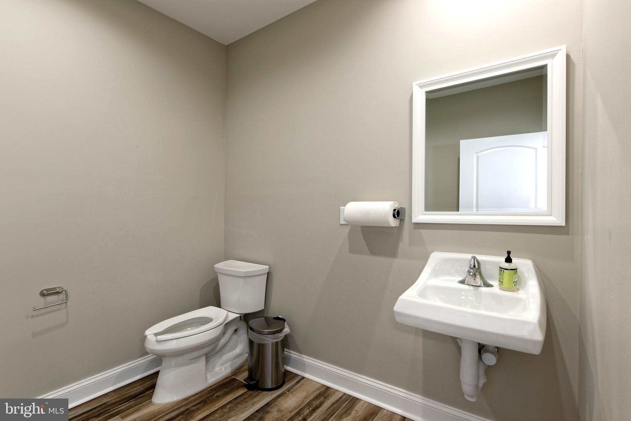 20615 Blue Ridge Mountain Road Paris, VA 20130 - Photo 58 of 80 a bathroom with a toilet sink and mirror