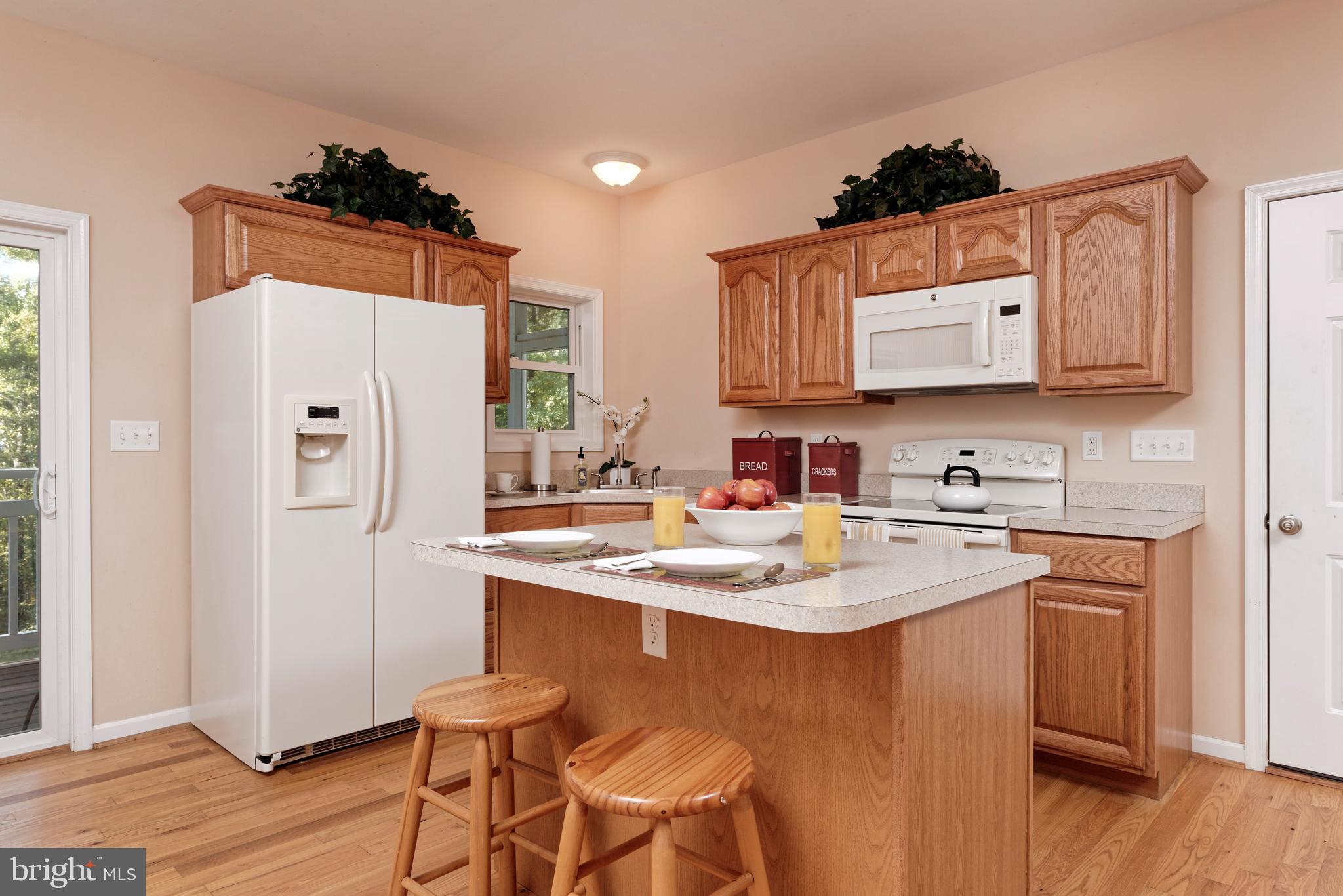20615 Blue Ridge Mountain Road Paris, VA 20130 - Photo 67 of 80 a kitchen with stainless steel appliances granite countertop a sink stove and refrigerator
