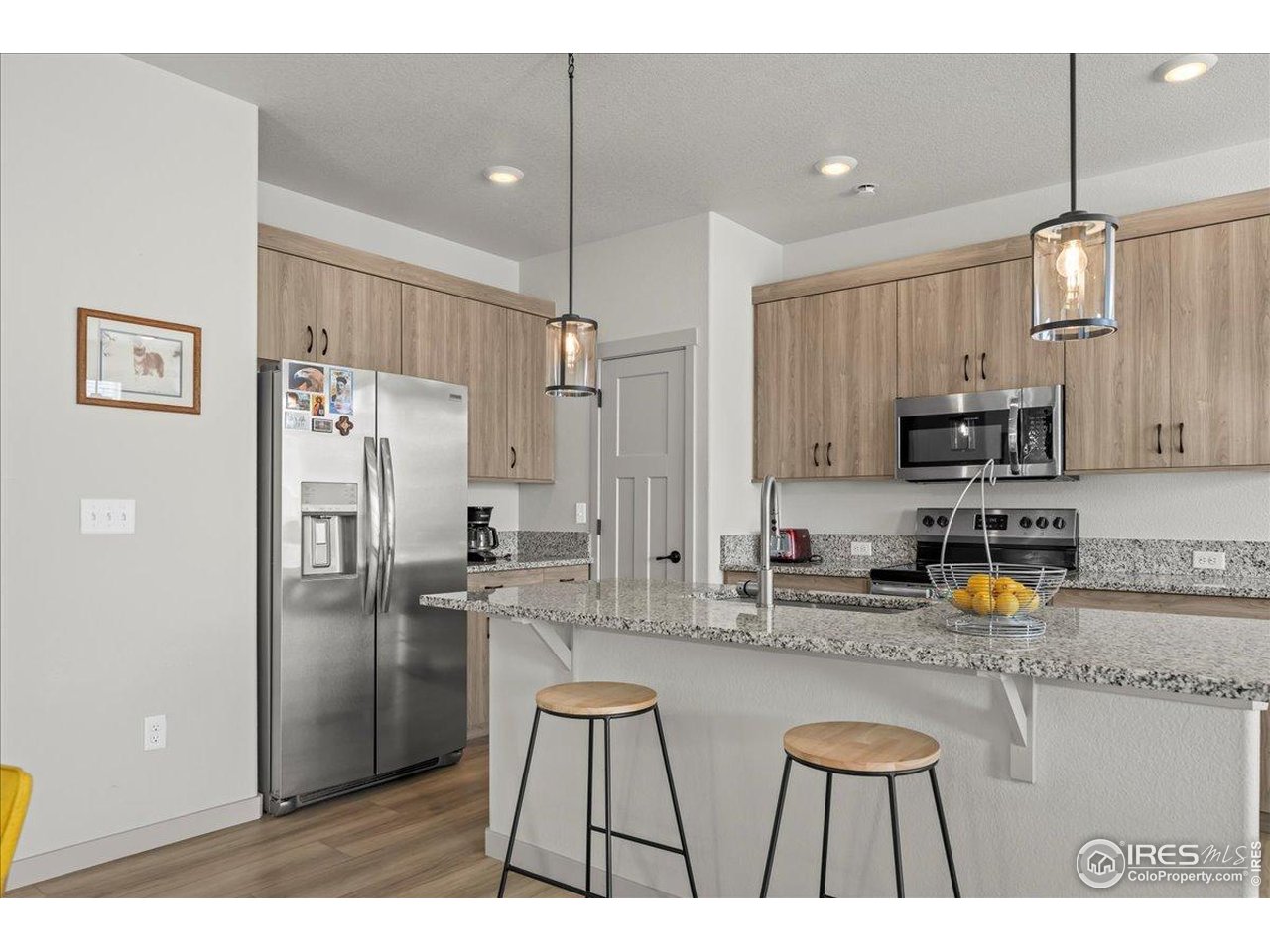 1088 Blue Bell Road Berthoud, CO 80513 - Photo 12 of 33 a kitchen with stainless steel appliances granite countertop a refrigerator a sink a stove a microwave and island