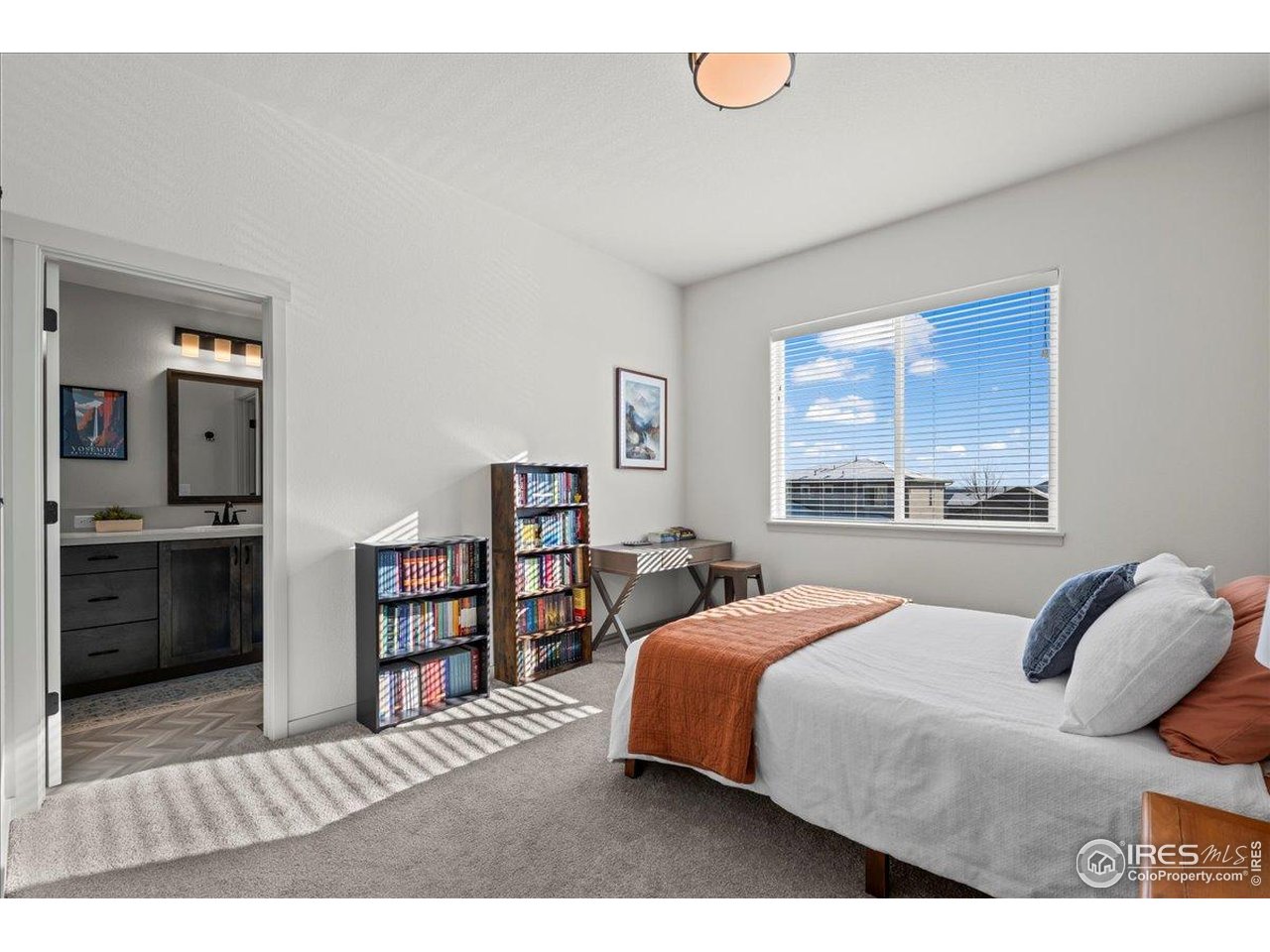 1088 Blue Bell Road Berthoud, CO 80513 - Photo 19 of 33 a bedroom with a bed and a book shelf