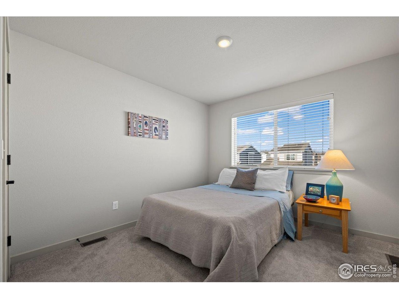 1088 Blue Bell Road Berthoud, CO 80513 - Photo 23 of 33 a bedroom with a bed and a cabinets