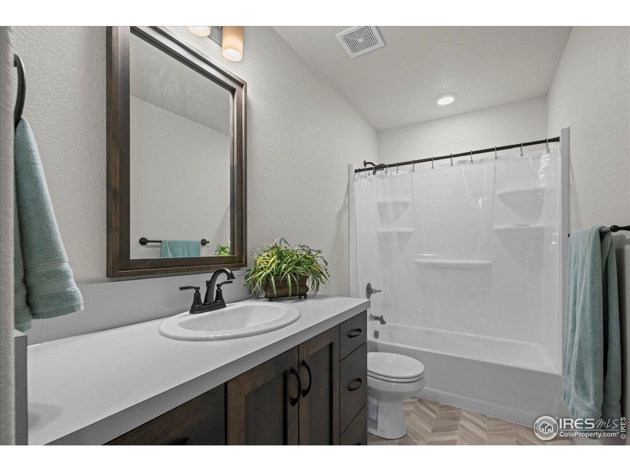 1088 Blue Bell Road Berthoud, CO 80513 - Photo 24 of 33 a bathroom with a sink a toilet and shower
