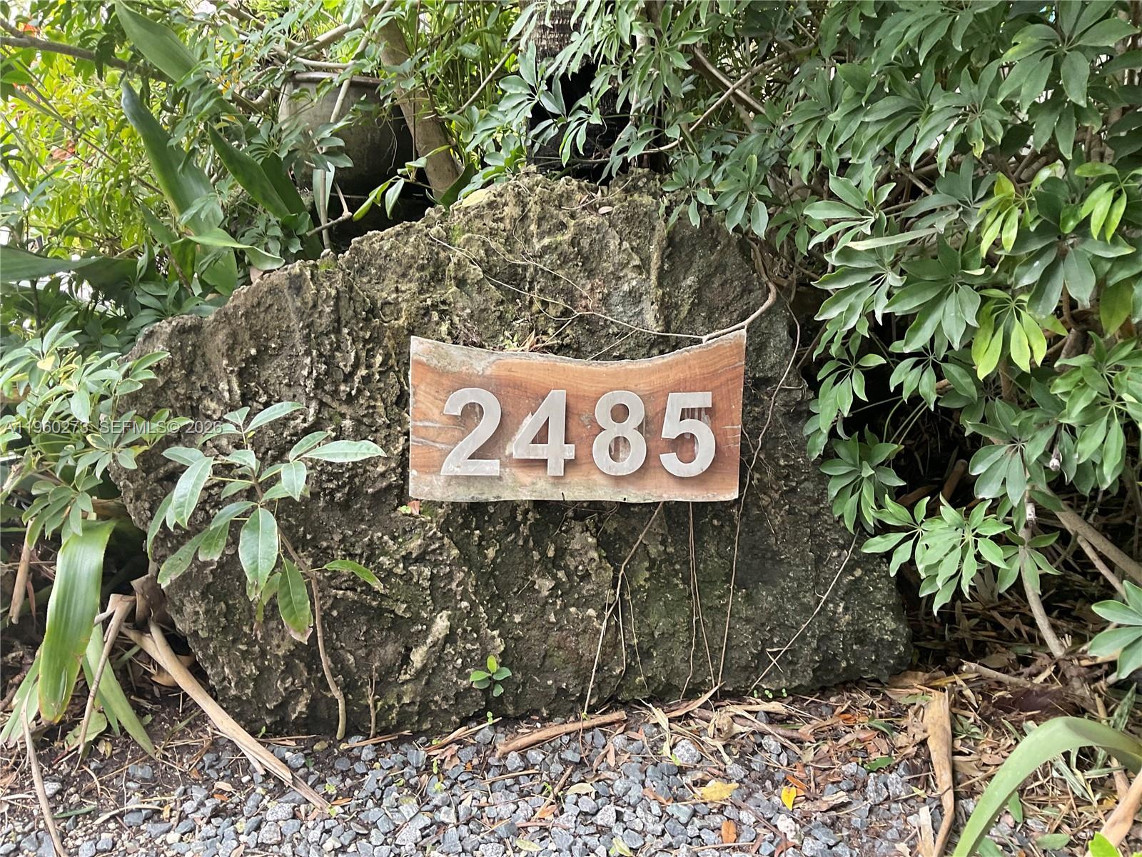 2485 Inagua Avenue Miami, FL 33133 - Photo 14 of 17 a sign that is on a brick wall