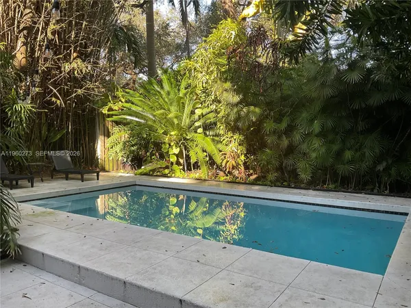 a view of a swimming pool with a yard