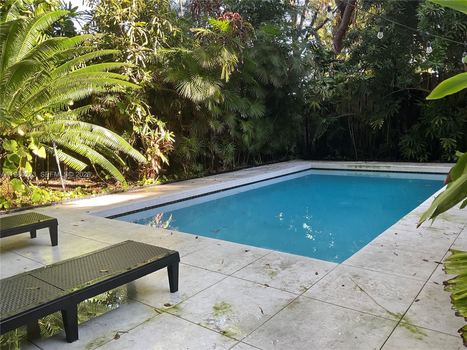 2485 Inagua Avenue Miami, FL 33133 - Photo 3 of 17 a view of a pool with a sitting area