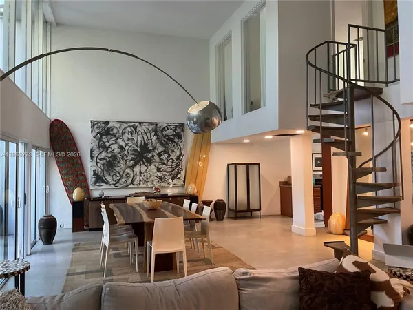 a view of a livingroom with furniture and staircase