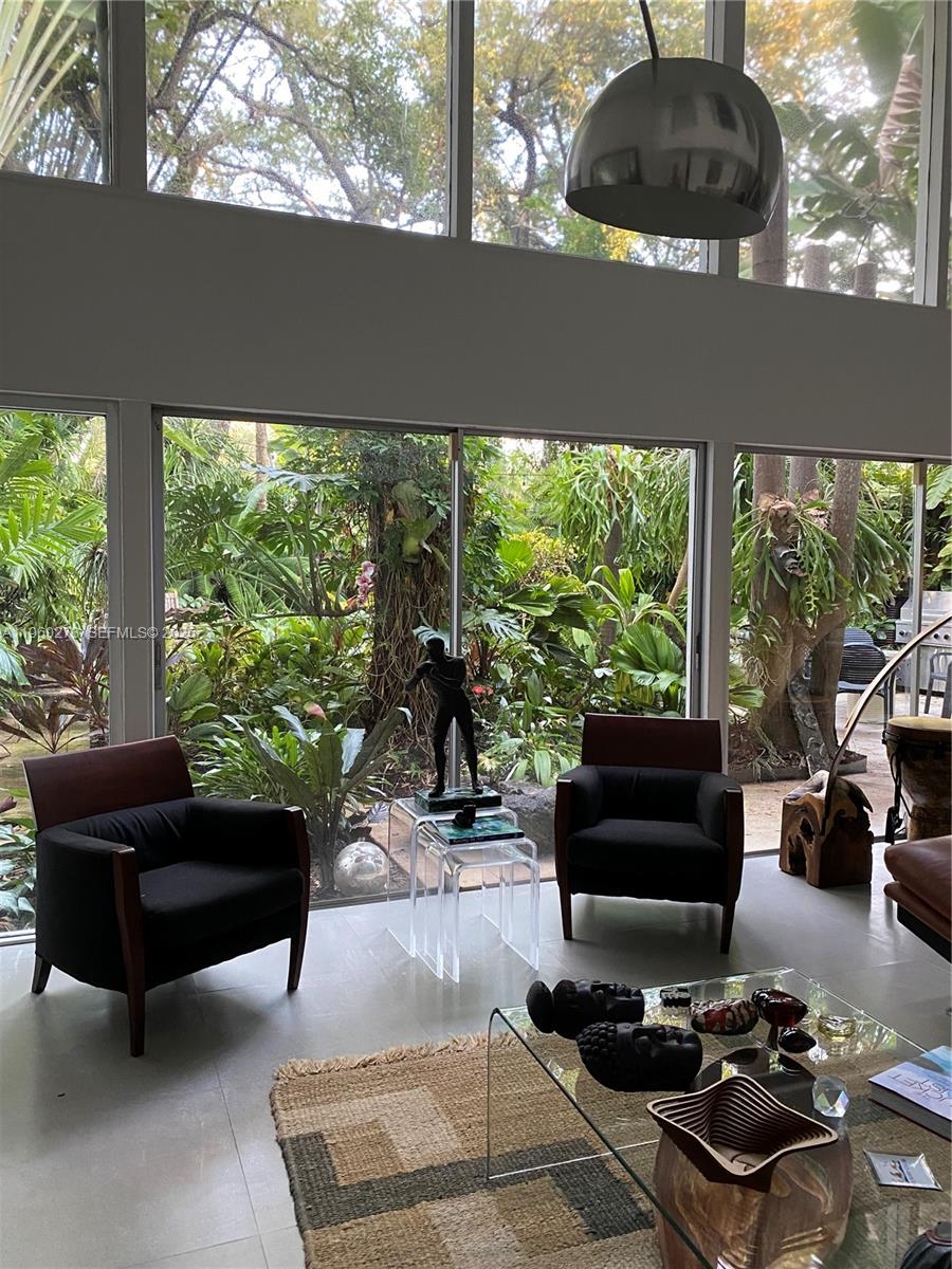 2485 Inagua Avenue Miami, FL 33133 - Photo 8 of 17 a living room with furniture and a floor to ceiling window