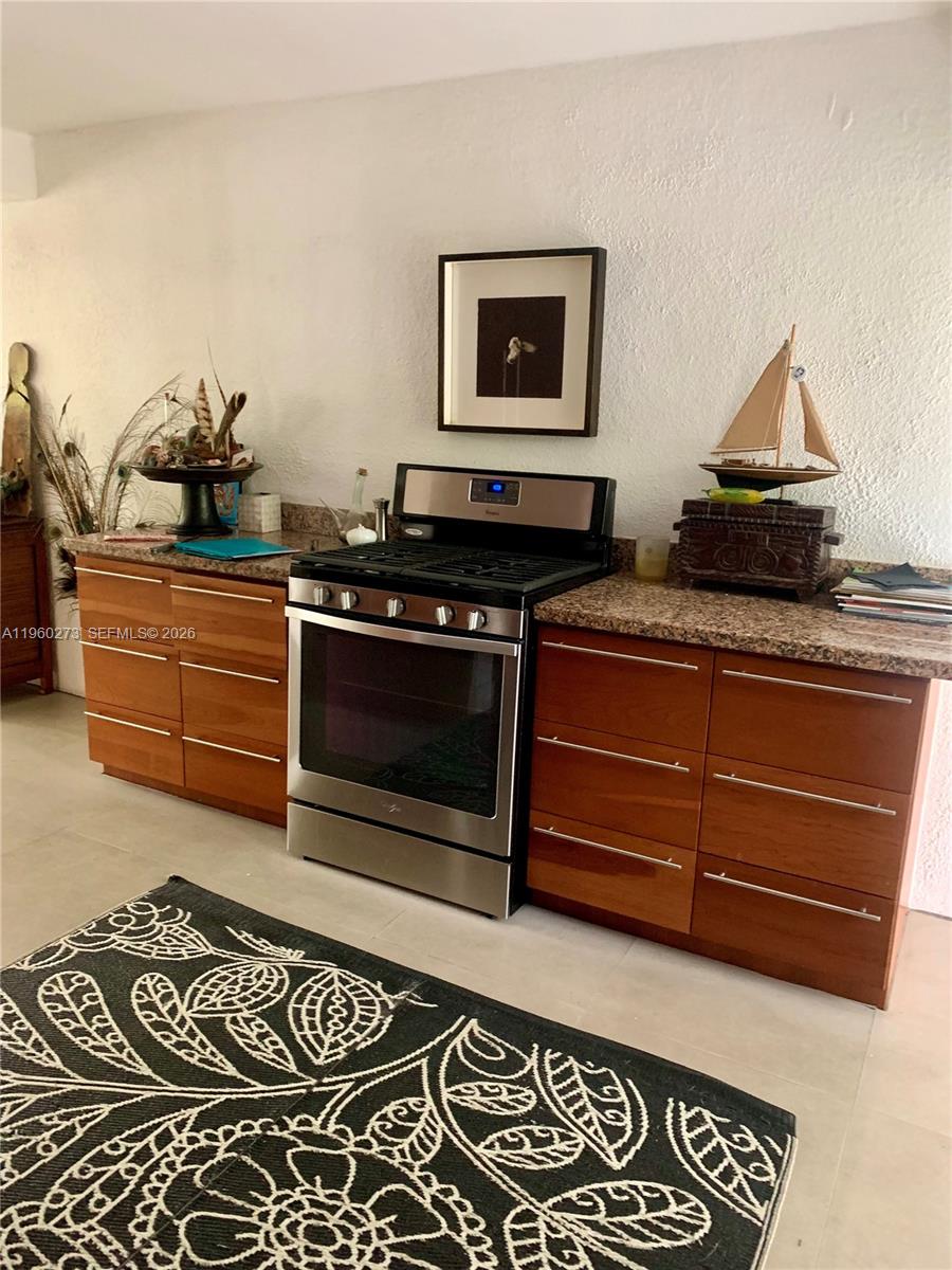 2485 Inagua Avenue Miami, FL 33133 - Photo 9 of 17 a kitchen with a stove and cabinets