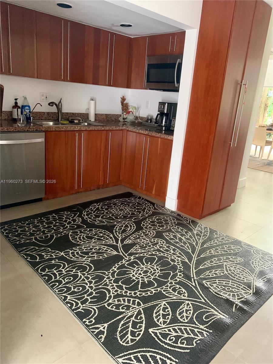 2485 Inagua Avenue Miami, FL 33133 - Photo 10 of 17 a kitchen with a sink and cabinets