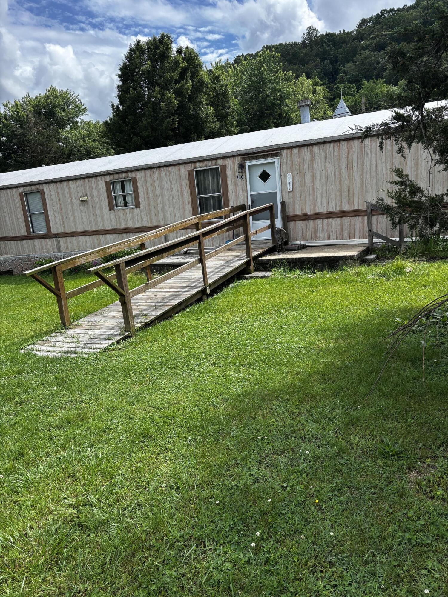 710 Commerce Avenue Iron Gate, VA 24448 - Photo 1 of 6 a view of a backyard with wooden fence