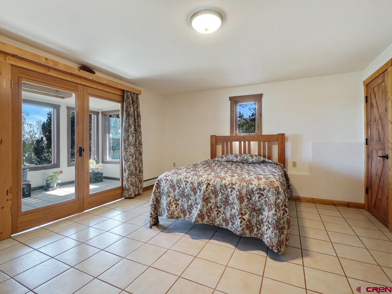 19795 High Park Road Cedaredge, CO 81413 - Photo 19 of 35 a bedroom with a bed and a window