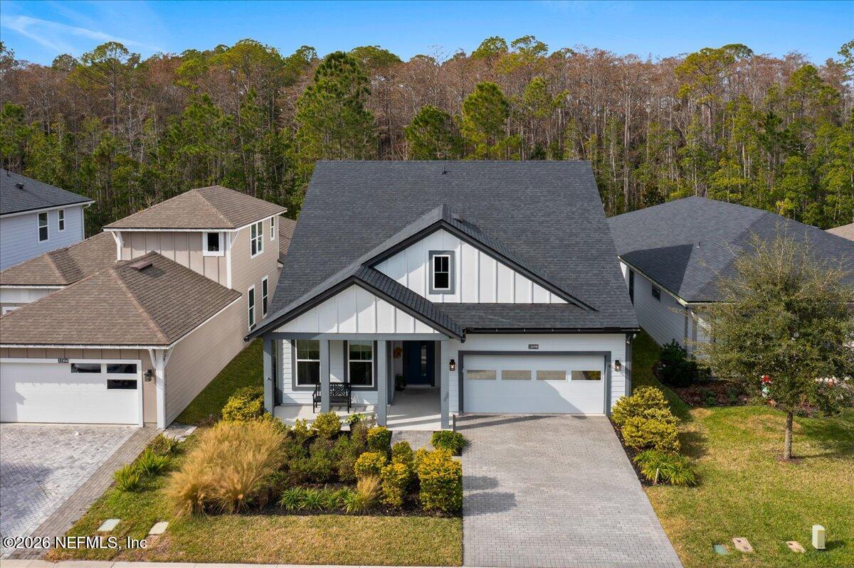 a aerial view of a house next to a yard