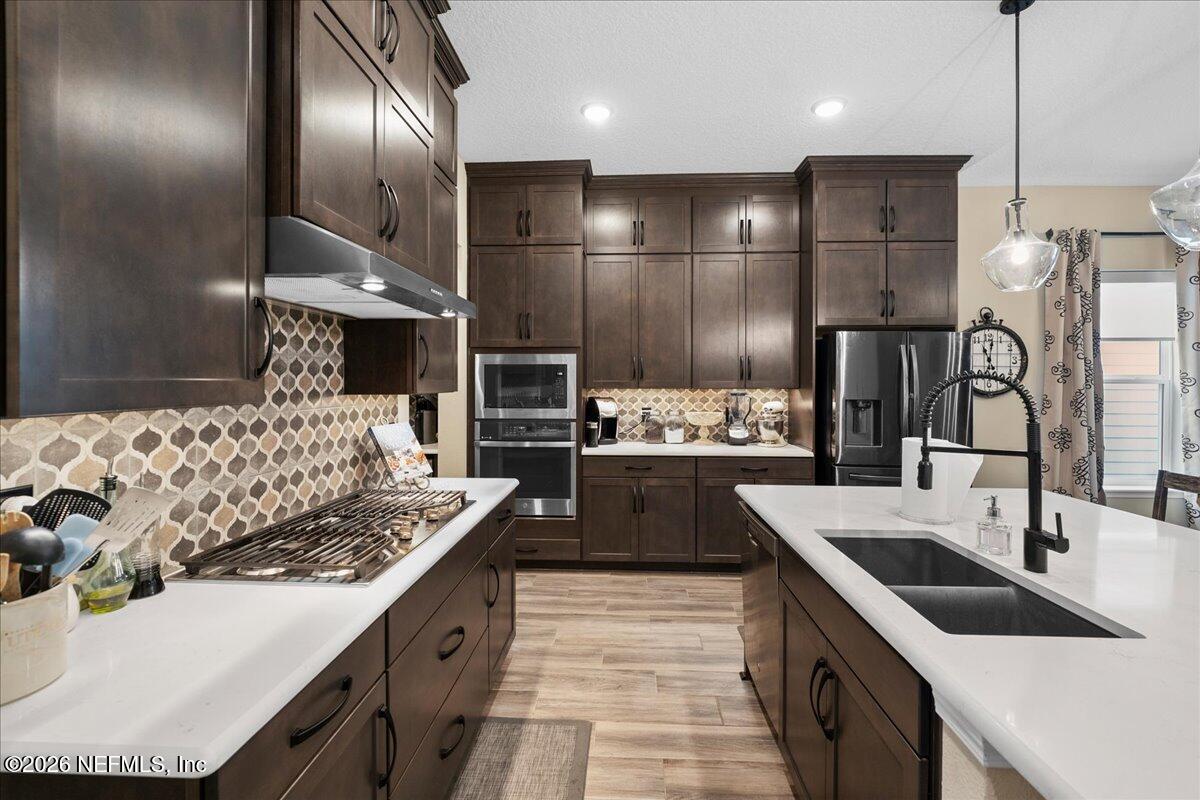 11098 Engineering Way Jacksonville, FL 32256 - Photo 11 of 62 a kitchen with stainless steel appliances kitchen island granite countertop a sink stove and refrigerator