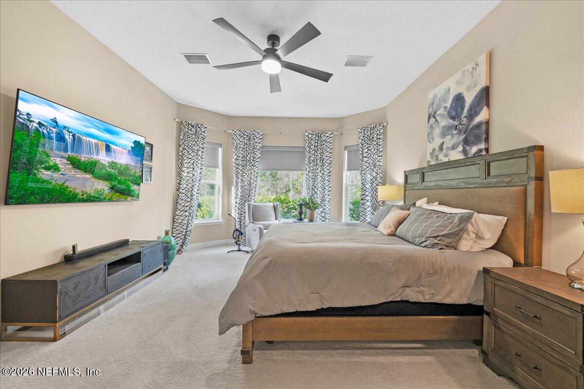 11098 Engineering Way Jacksonville, FL 32256 - Photo 18 of 62 a bedroom with a bed and a flat screen tv