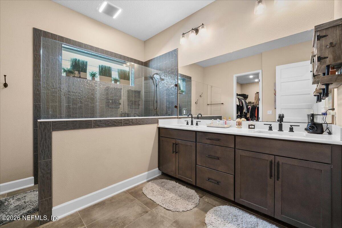 11098 Engineering Way Jacksonville, FL 32256 - Photo 20 of 62 a bathroom with a double vanity sink and mirror