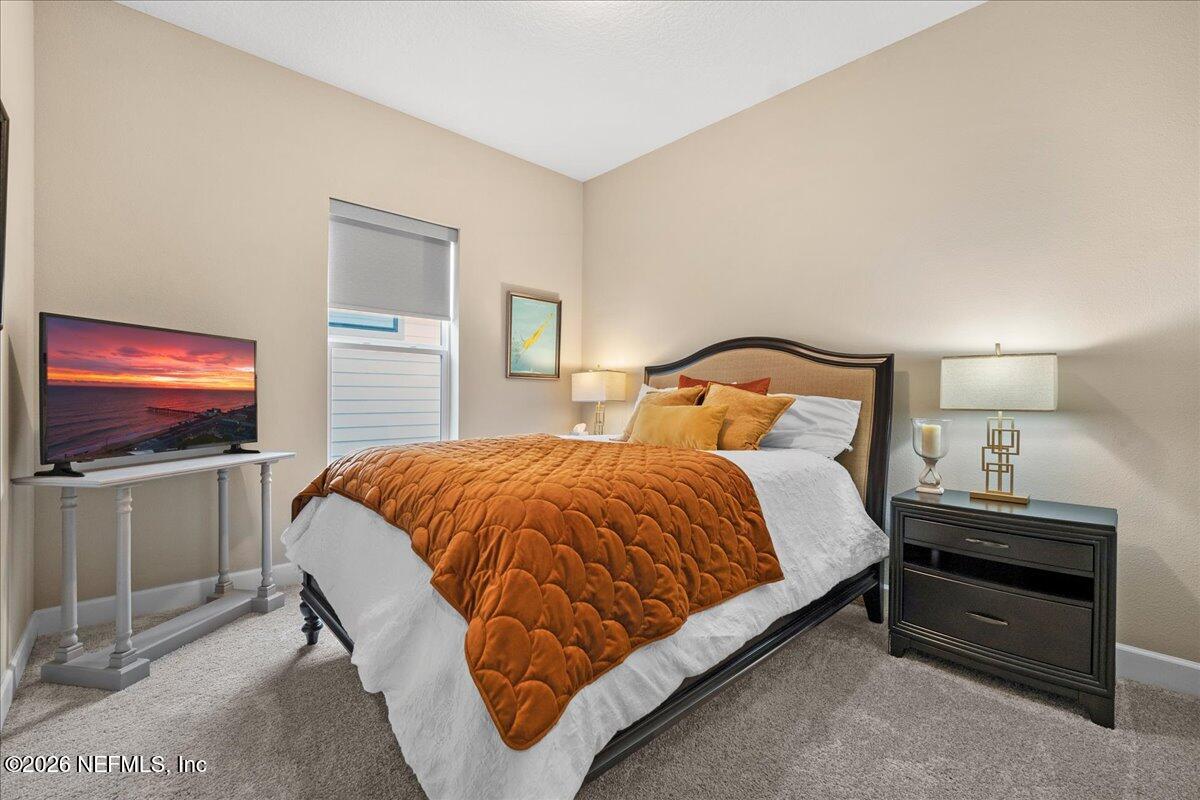 11098 Engineering Way Jacksonville, FL 32256 - Photo 24 of 62 a bedroom with a bed and a flat screen tv