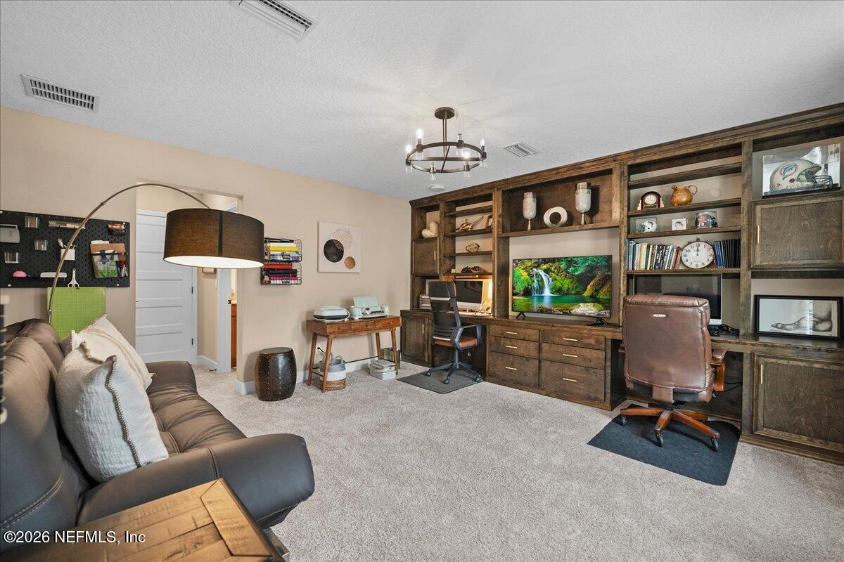 11098 Engineering Way Jacksonville, FL 32256 - Photo 28 of 62 a living room with furniture and a flat screen tv