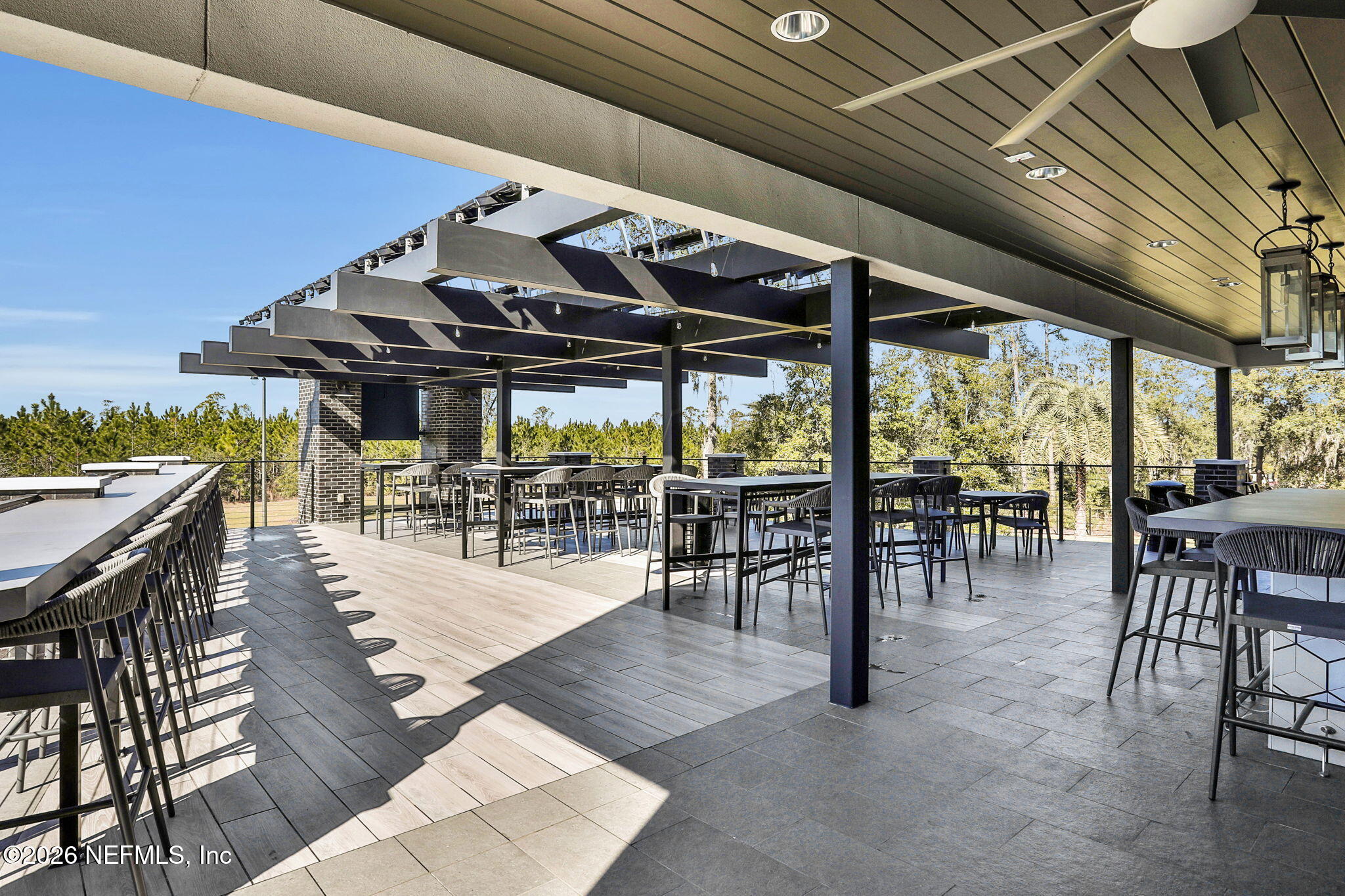 11098 Engineering Way Jacksonville, FL 32256 - Photo 54 of 62 a view of a patio with table and chairs floor to ceiling window with wooden floor