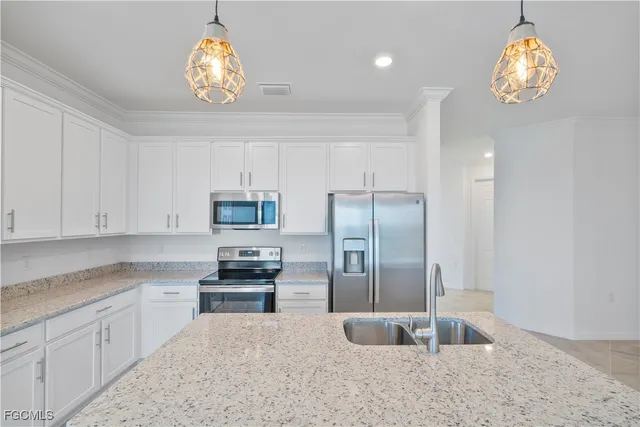 a kitchen with granite countertop a refrigerator oven a sink and dishwasher