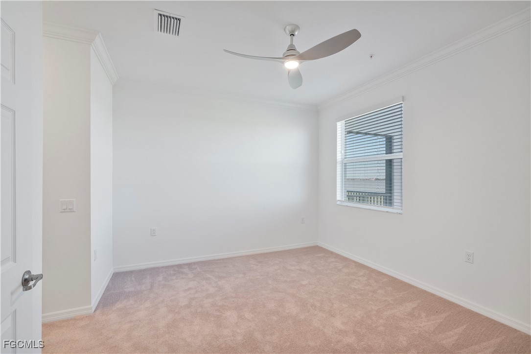 43977 Boardwalk Loop, Unit 2338 Punta Gorda, FL 33982 - Photo 13 of 50 an empty room with a chandelier fan and windows