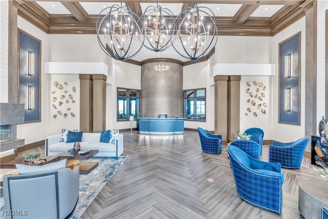 43977 Boardwalk Loop, Unit 2338 Punta Gorda, FL 33982 - Photo 26 of 50 a living room with furniture a chandelier and a large mirror