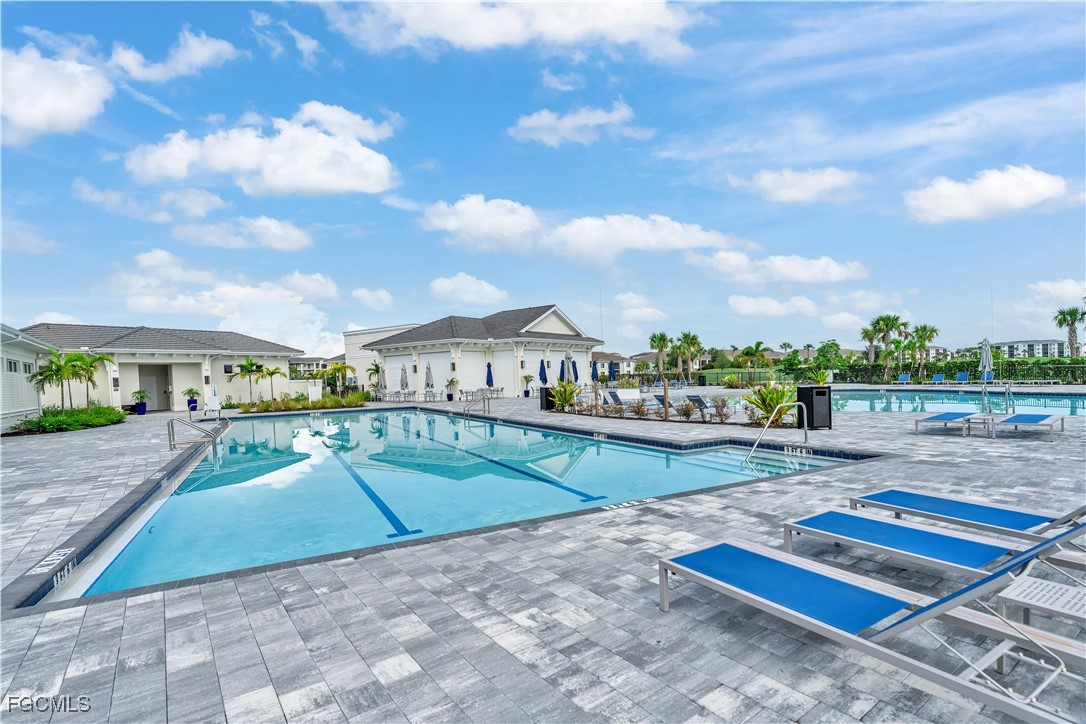 43977 Boardwalk Loop, Unit 2338 Punta Gorda, FL 33982 - Photo 39 of 50 a view of a swimming pool and lounge chairs