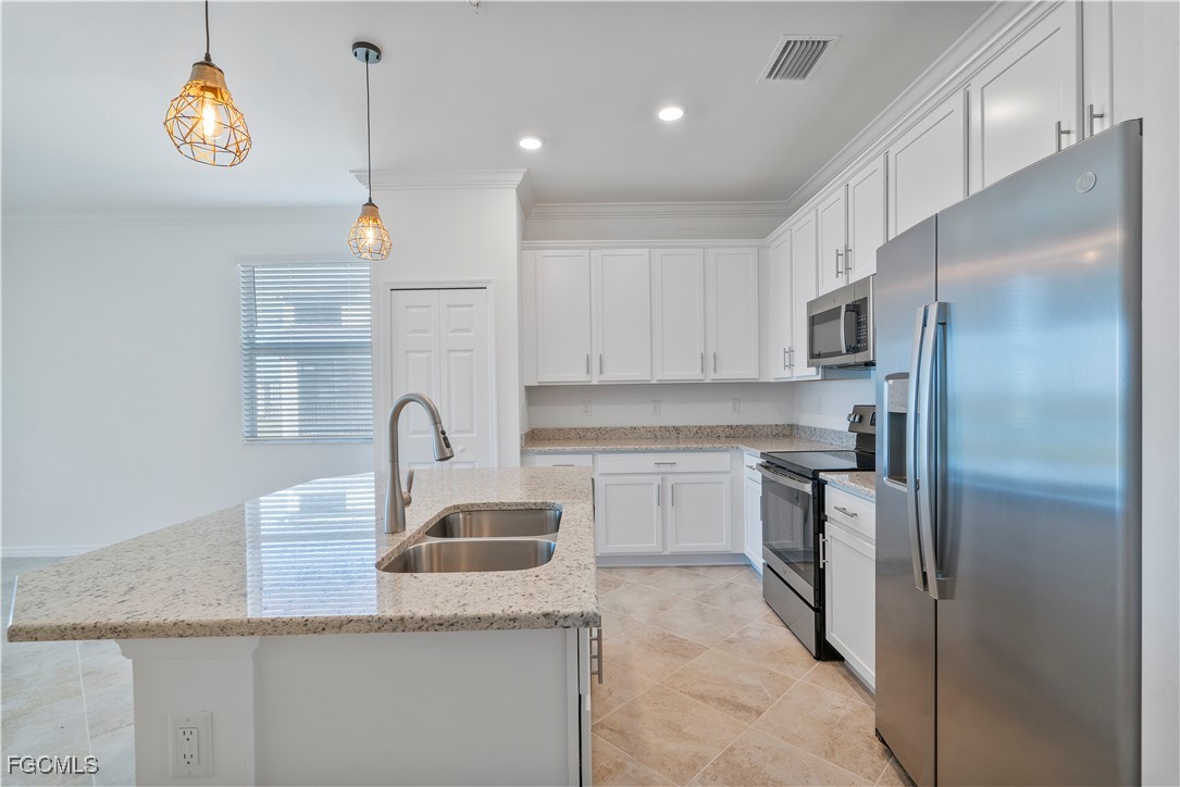 43977 Boardwalk Loop, Unit 2338 Punta Gorda, FL 33982 - Photo 8 of 50 a kitchen with kitchen island granite countertop a sink stainless steel appliances and cabinets
